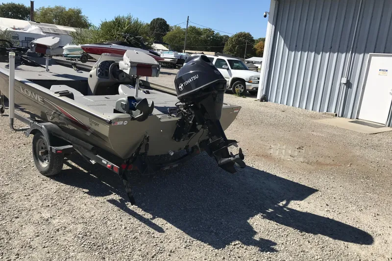 Slide: The Image of 2007 Lowe Stinger 170 boat with Tohatsu motor on trailer, parked outdoors. - 14