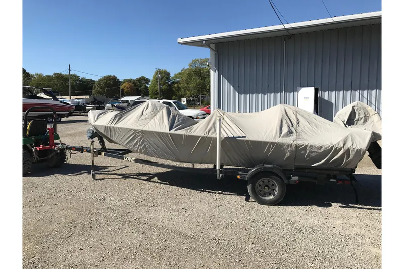 Slide: The Image of 2007 Lowe Stinger 170 boat covered on trailer in outdoor storage area. - 15