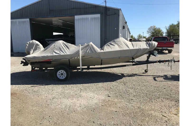 Slide: The Image of Covered 2007 Lowe Stinger 170 boat on trailer outside a metal building. - 17