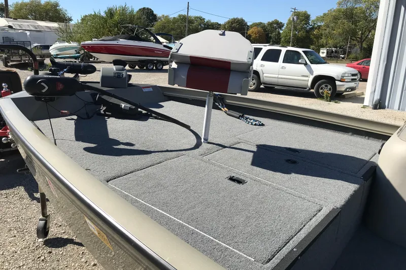 Slide: The Image of 2007 Lowe Stinger 170 boat with carpeted deck and trolling motor in a parking lot. - 22