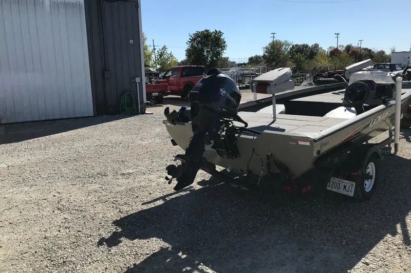 Slide: The Image of 2007 Lowe Stinger 170 boat with Tohatsu motor in a gravel lot. - 9