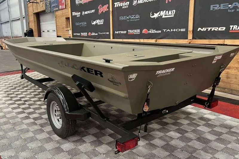 Slide: The Image of 2026 Tracker Grizzly 1754 Utility boat on trailer in showroom. - 3