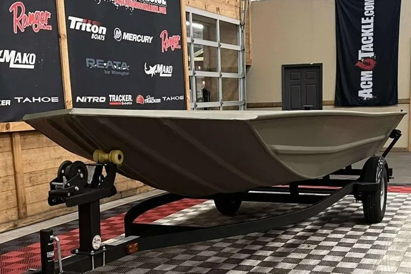 Slide: The Image of 2026 Tracker Grizzly 1754 Utility boat on trailer in showroom. - 5