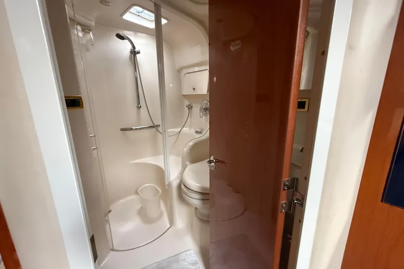 Slide: The Image of Bathroom interior of 2001 Sea Ray 410 Sundancer yacht, featuring shower and toilet. - 15