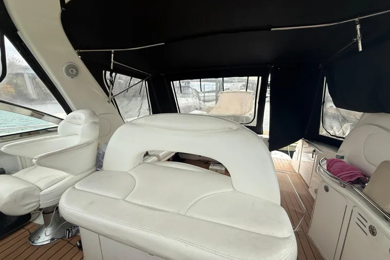 Slide: The Image of Interior of 2001 Sea Ray 410 Sundancer with white seating and wood flooring. - 19