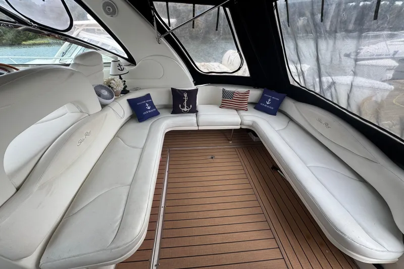 Slide: The Image of Luxurious 2001 Sea Ray 410 Sundancer interior with white seating and nautical decor. - 2