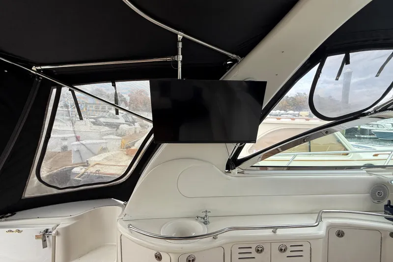 Slide: The Image of 2001 Sea Ray 410 Sundancer interior with mounted TV and sleek design. - 20