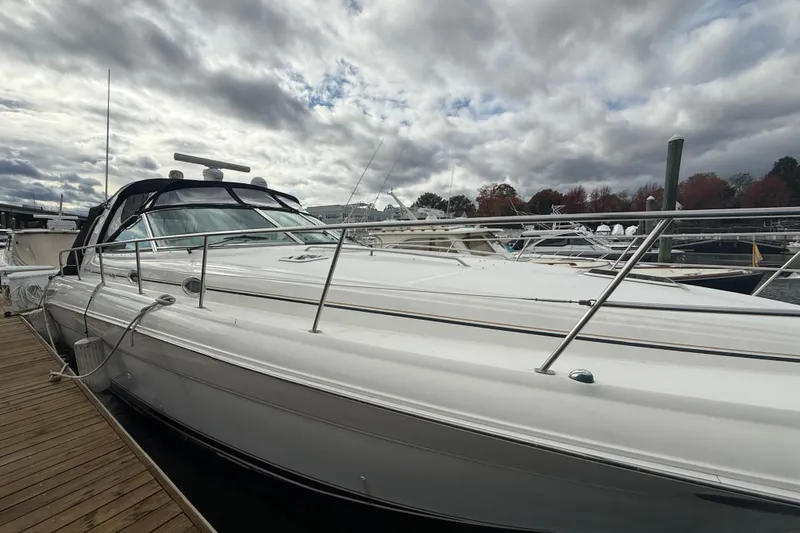 Slide: The Image of 2001 Sea Ray 410 Sundancer yacht docked under cloudy skies. - 23