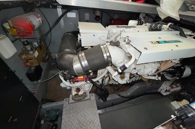 Slide: The Image of Engine room of a 2001 Sea Ray 410 Sundancer, showcasing mechanical components and fire extinguisher. - 24