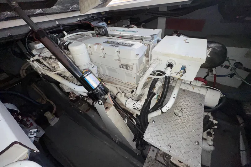 Slide: The Image of Engine room of a 2001 Sea Ray 410 Sundancer boat, showcasing mechanical components. - 25