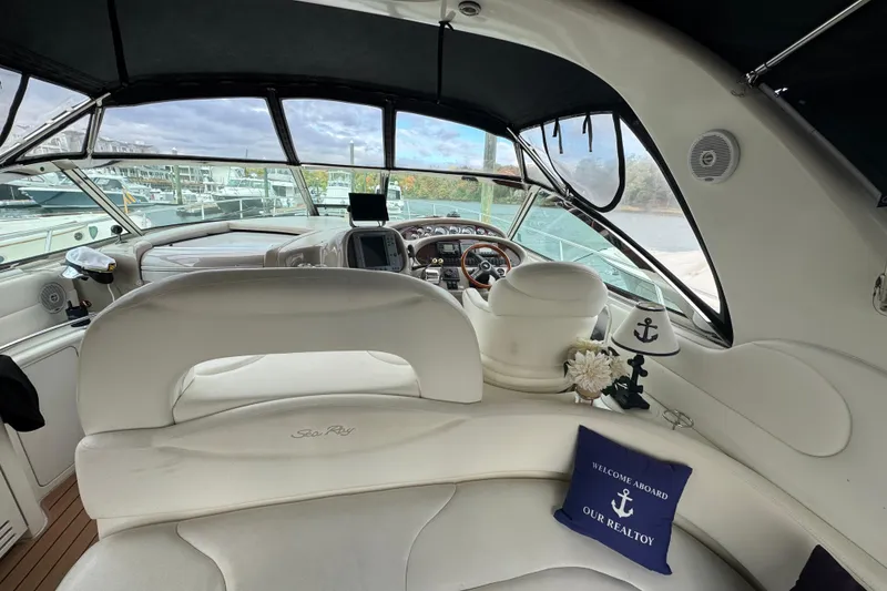 Slide: The Image of Interior of 2001 Sea Ray 410 Sundancer yacht with white seating and nautical decor. - 3
