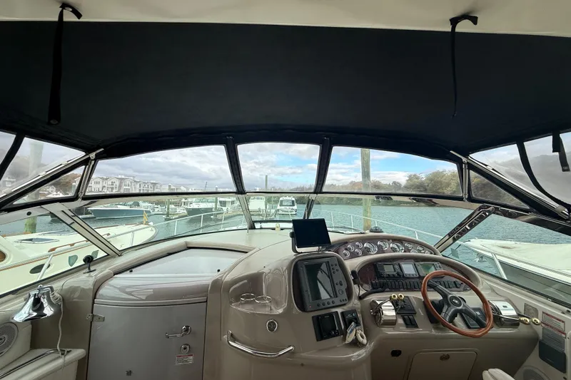 Slide: The Image of Interior view of 2001 Sea Ray 410 Sundancer yacht cockpit with steering wheel and controls. - 4