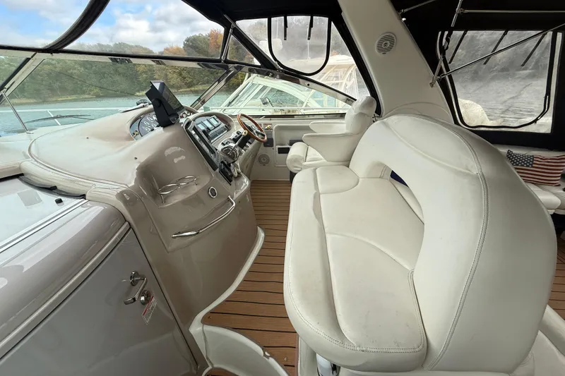 Slide: The Image of 2001 Sea Ray 410 Sundancer cockpit with white seating and modern dashboard controls. - 5