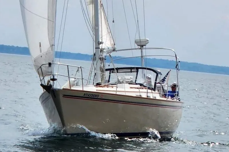 The Image of 1984 Pearson 386 sailboat navigating calm waters with sails unfurled. - 0