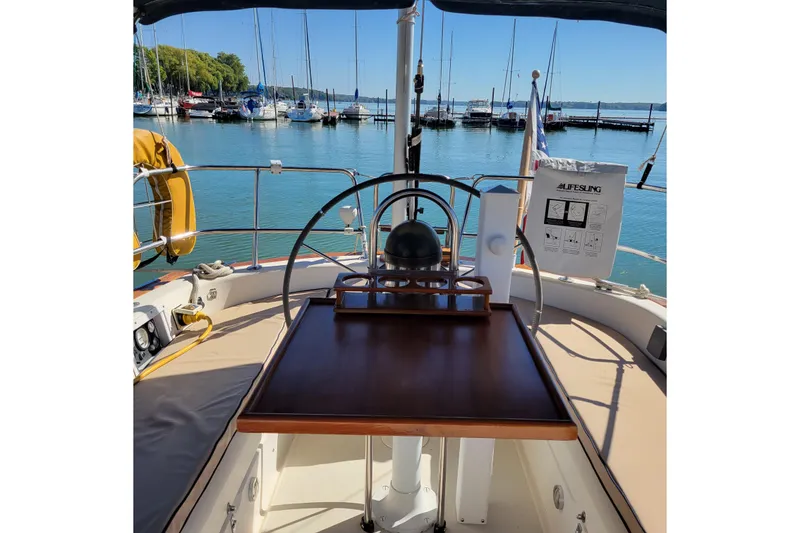 Slide: The Image of Cockpit of 1984 Pearson 386 sailboat with marina view in background. - 17