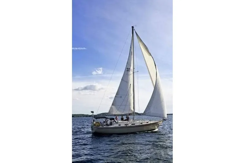 Slide: The Image of 1984 Pearson 386 sailboat cruising on open water under clear skies. - 3