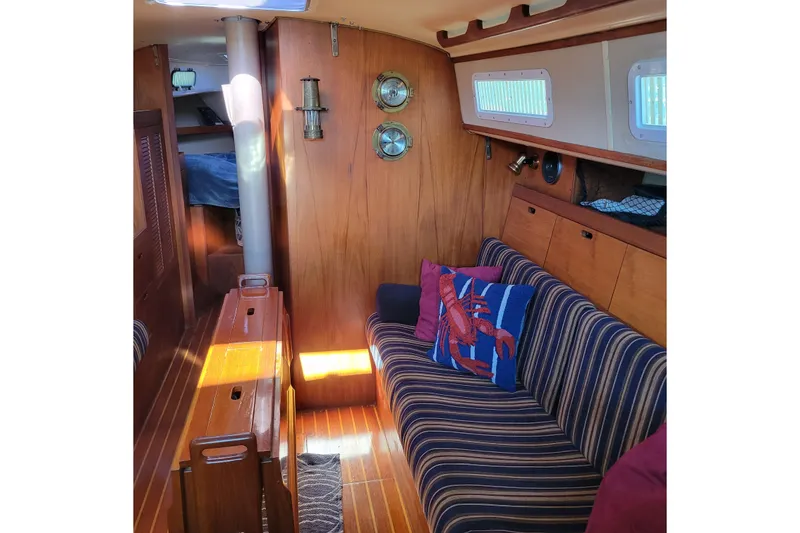 Slide: The Image of Interior of a 1984 Pearson 386 sailboat with striped seating and nautical decor. - 31