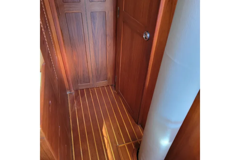 Slide: The Image of Wooden interior of 1984 Pearson 386 sailboat, featuring polished doors and striped flooring. - 37