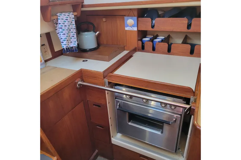 Slide: The Image of Galley kitchen in 1984 Pearson 386 sailboat with stove and kettle. - 38