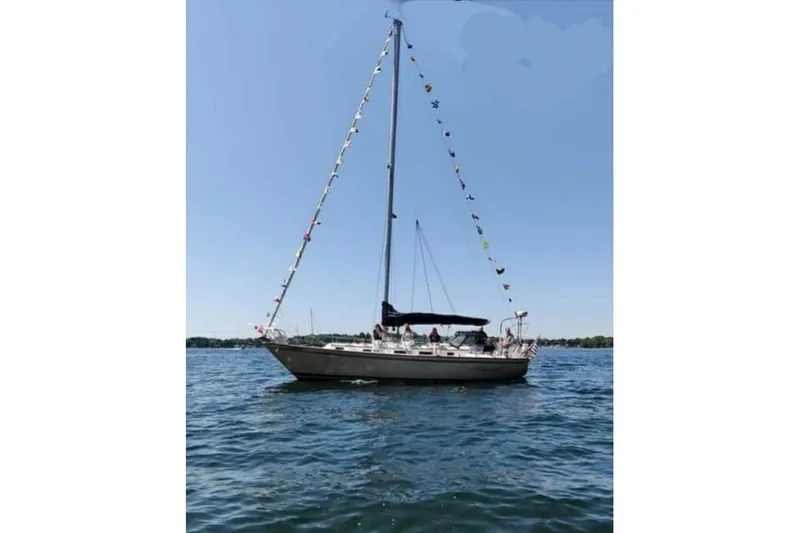 Slide: The Image of Sailboat on water, Pearson 386, 1984 model, decorated with flags under clear blue sky. - 5