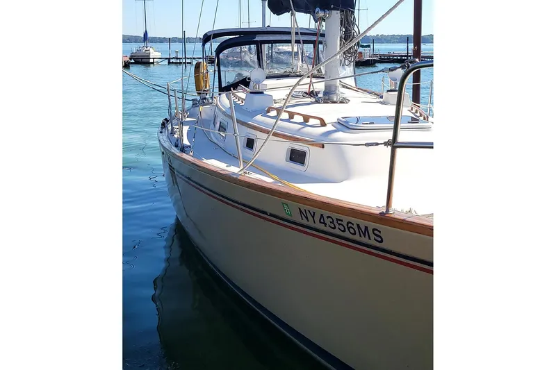 Slide: The Image of 1984 Pearson 386 sailboat docked on calm water, showcasing sleek design and registration number NY4356MS. - 8