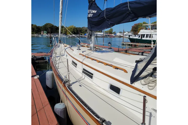 Slide: The Image of 1984 Pearson 386 sailboat docked at a marina on a sunny day. - 12