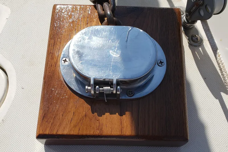 Slide: The Image of Polished metal deck fitting on 1984 Pearson 386 sailboat, mounted on wooden base. - 15