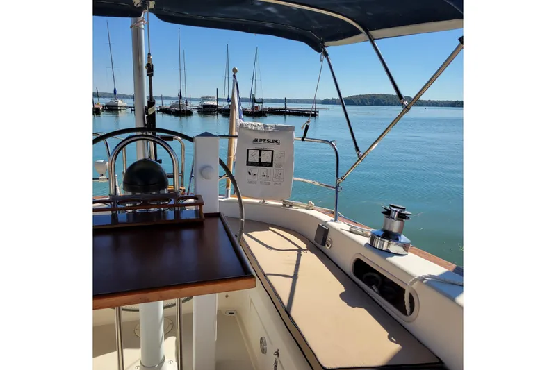 Slide: The Image of Cockpit of 1984 Pearson 386 sailboat with marina view and Lifesling safety equipment. - 18