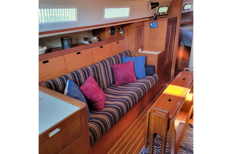 Slide: The Image of Interior of 1984 Pearson 386 sailboat with striped sofa and colorful cushions. - 30