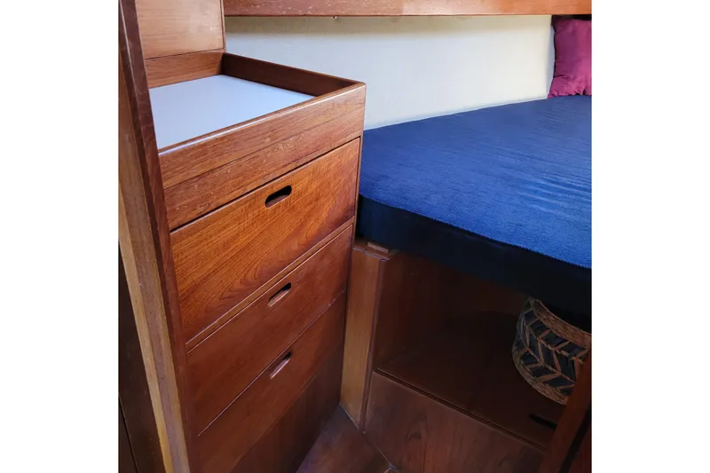 Slide: The Image of Wooden interior of 1984 Pearson 386 sailboat with drawers and blue bedding. - 32