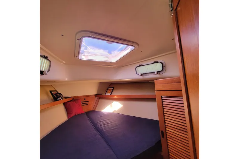 Slide: The Image of Cozy cabin interior of 1984 Pearson 386 sailboat with skylight and wooden accents. - 33
