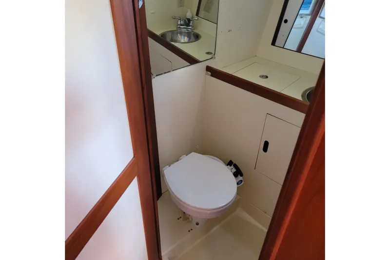 Slide: The Image of 1984 Pearson 386 yacht bathroom with toilet, sink, and mirror. - 39