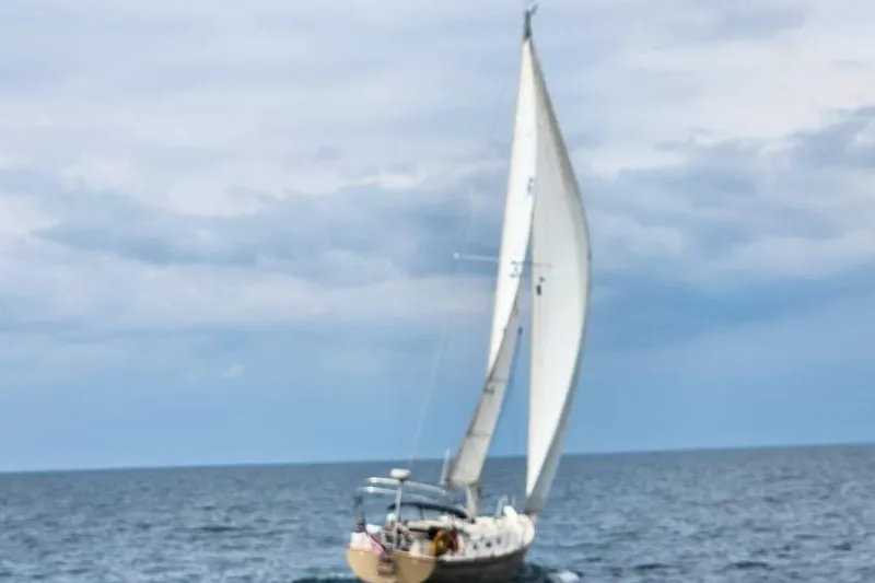 Slide: The Image of Sailboat Pearson 386 from 1984 navigating on open sea under cloudy skies. - 4