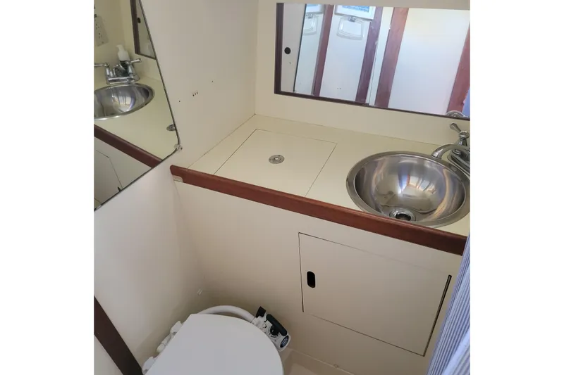 Slide: The Image of 1984 Pearson 386 yacht bathroom with sink, mirror, and toilet. - 40