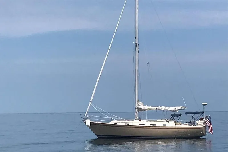 Slide: The Image of 1984 Pearson 386 sailboat on calm water with clear sky background. - 6