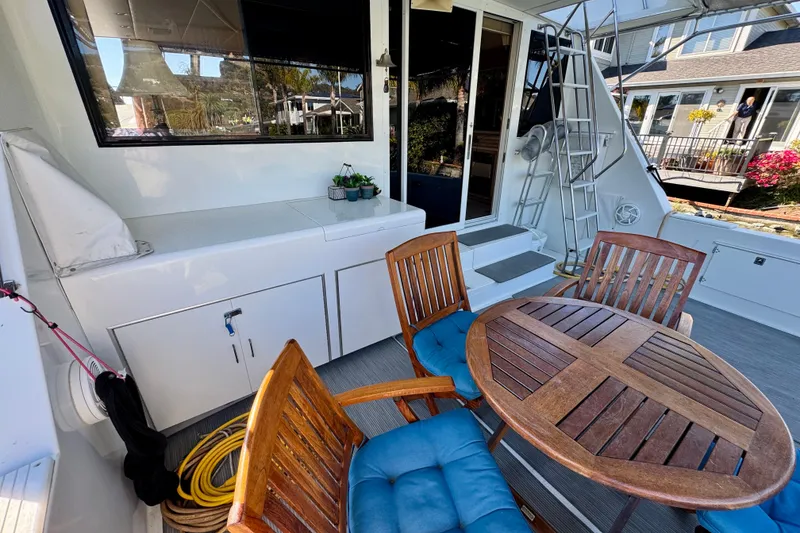 Slide: The Image of Outdoor seating on 1993 Tollycraft 57 Pilothouse Motor Yacht with blue-cushioned chairs. - 12