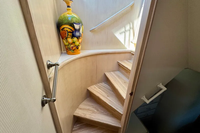 Slide: The Image of 1993 Tollycraft 57 Pilothouse Motor Yacht kitchen with stove and wooden cabinetry. - 17