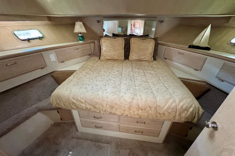 Slide: The Image of Luxurious bedroom in 1993 Tollycraft 57 Pilothouse Motor Yacht with elegant bedding and ample storage. - 21