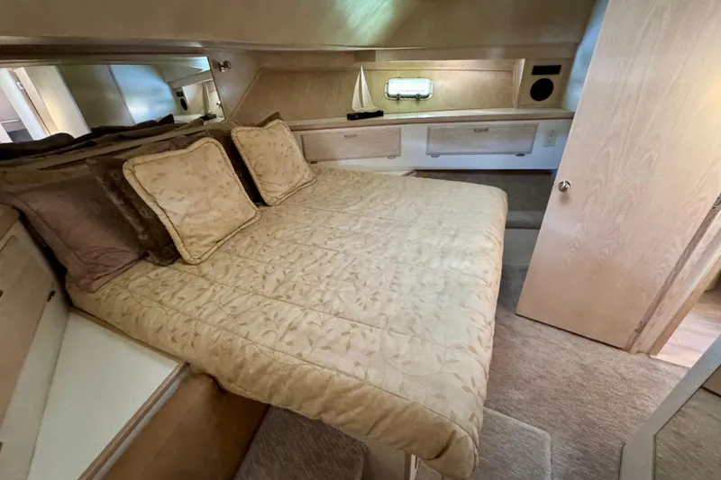 Slide: The Image of Luxurious 1993 Tollycraft 57 Pilothouse Motor Yacht bedroom with cozy bedding and elegant decor. - 22