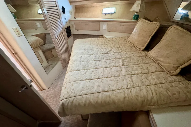 Slide: The Image of Luxurious bedroom interior of 1993 Tollycraft 57 Pilothouse Motor Yacht with elegant bedding. - 23