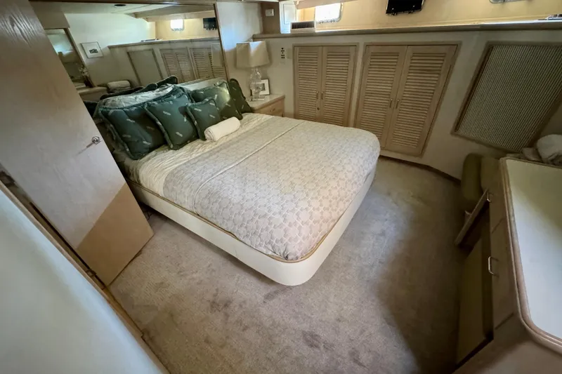 Slide: The Image of Luxurious bedroom in 1993 Tollycraft 57 Pilothouse Motor Yacht with cozy bedding and elegant decor. - 32