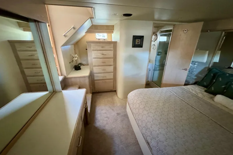 Slide: The Image of Luxurious bedroom interior of 1993 Tollycraft 57 Pilothouse Motor Yacht with elegant bedding. - 33