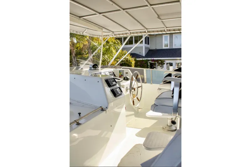 Slide: The Image of 1993 Tollycraft 57 Pilothouse Motor Yacht upper deck with seating and controls. - 35