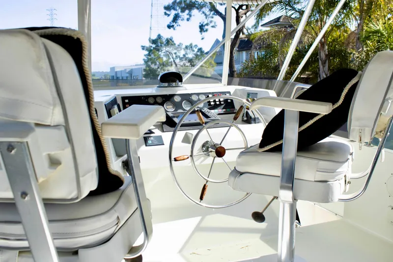 Slide: The Image of 1993 Tollycraft 57 Pilothouse Motor Yacht helm with steering wheel and navigation equipment. - 36