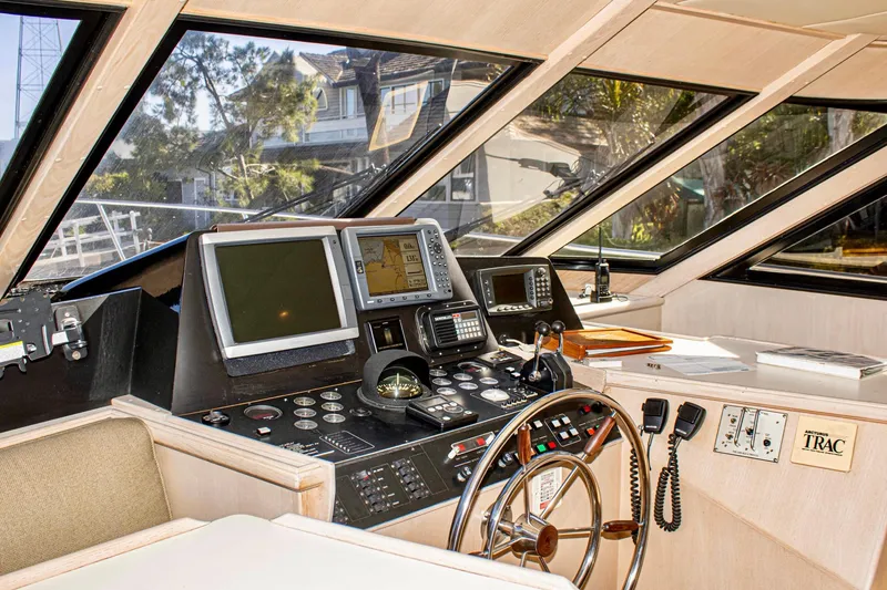 Slide: The Image of 1993 Tollycraft 57 Pilothouse Motor Yacht helm with navigation equipment and steering wheel. - 39