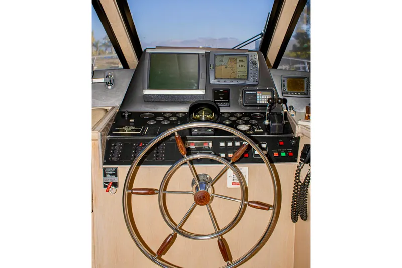 Slide: The Image of Pilothouse interior of 1993 Tollycraft 57 Motor Yacht with navigation equipment and steering wheel. - 40