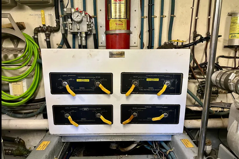 Slide: The Image of Engine room of 1993 Tollycraft 57 Pilothouse Motor Yacht, showcasing dual engines and mechanical components. - 47