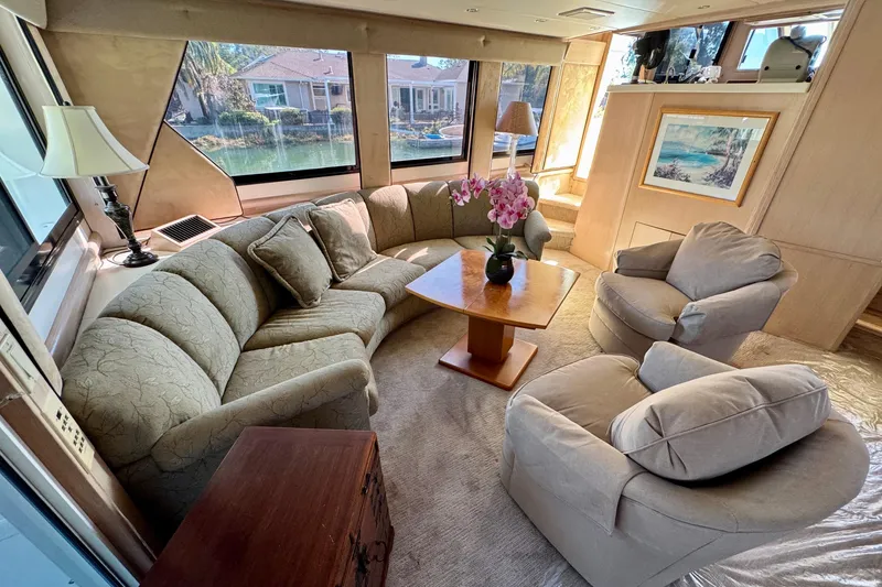 Slide: The Image of Luxurious interior of 1993 Tollycraft 57 Pilothouse Motor Yacht with elegant seating and scenic views. - 7