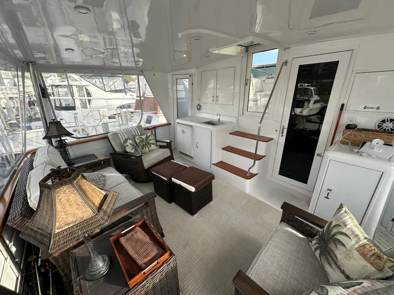 Slide: The Image of Luxurious 1994 Hatteras 48 Cockpit MY interior with elegant seating and modern amenities. - 11