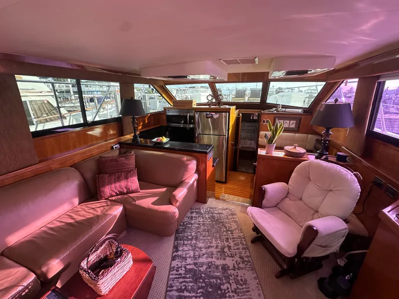 Slide: The Image of Luxurious interior of 1994 Hatteras 48 Cockpit MY yacht with cozy seating and elegant decor. - 15